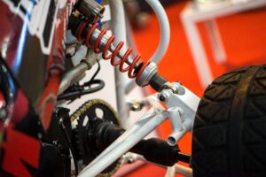 Racing car wheel and shock absorber. Selective focus shock absorber of buggy car in parking
